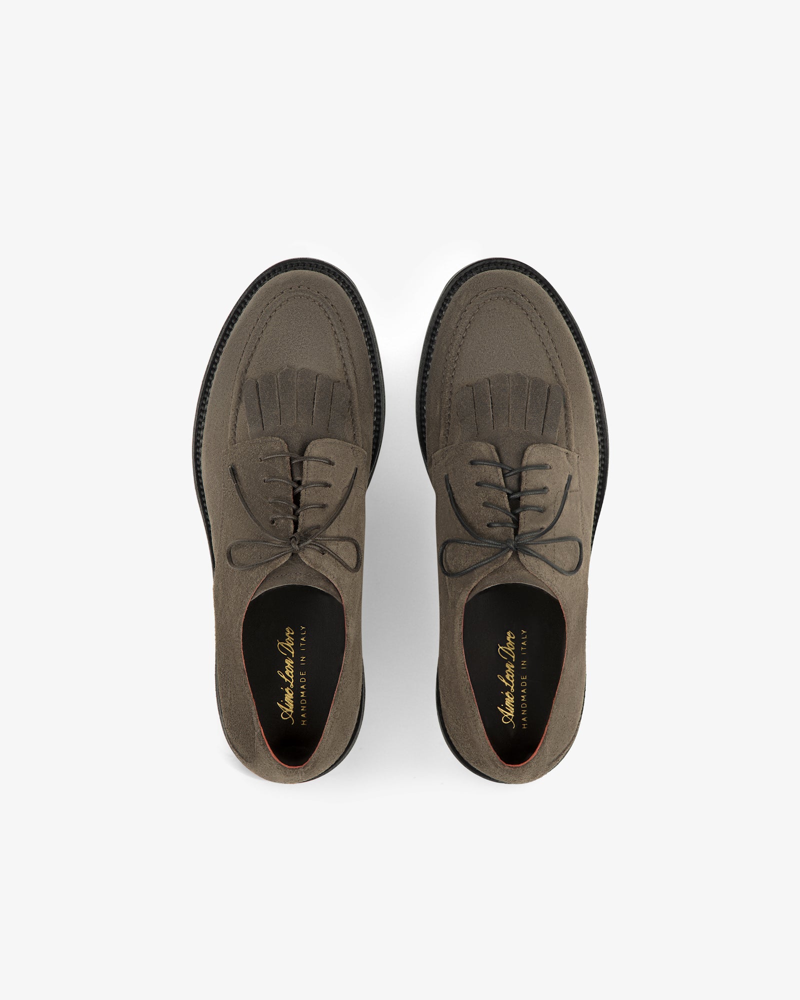 Suede Lug Sole Derby: brown suede lace-up shoes with brogue detailing and fringe on a white background.