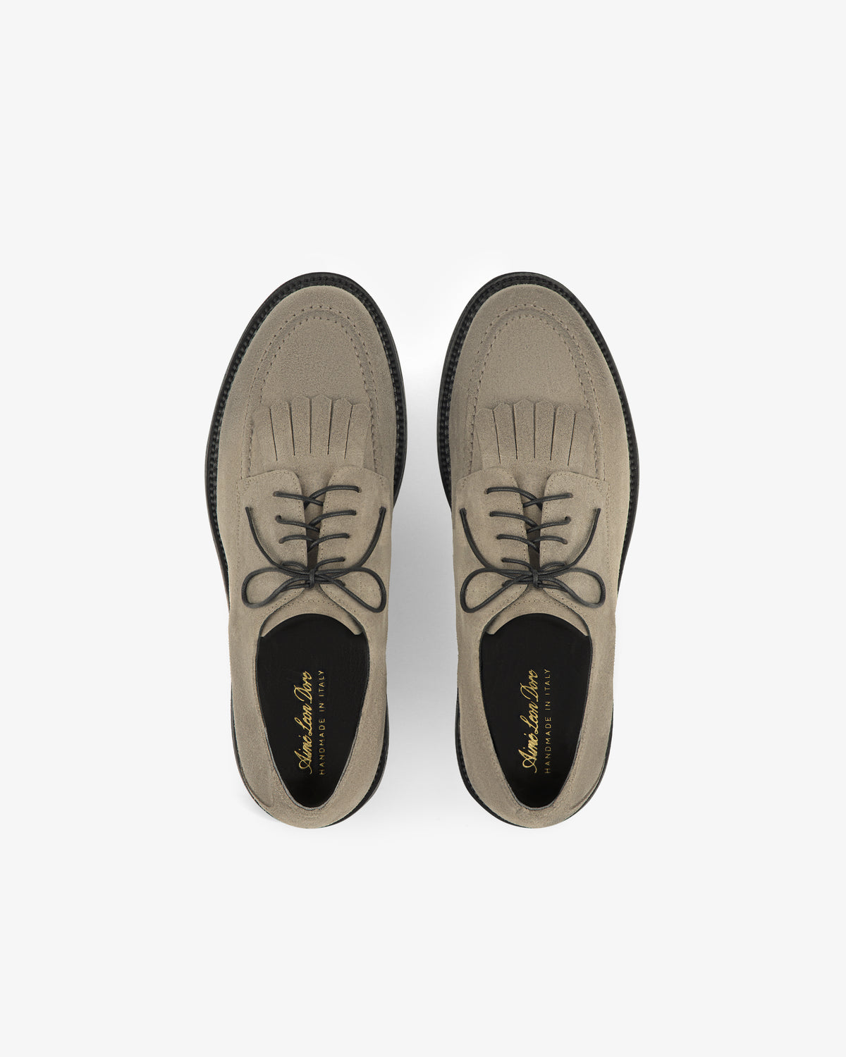 Top view of Suede Lug Sole Derby shoes in light brown, with black laces and soles, on a white background.