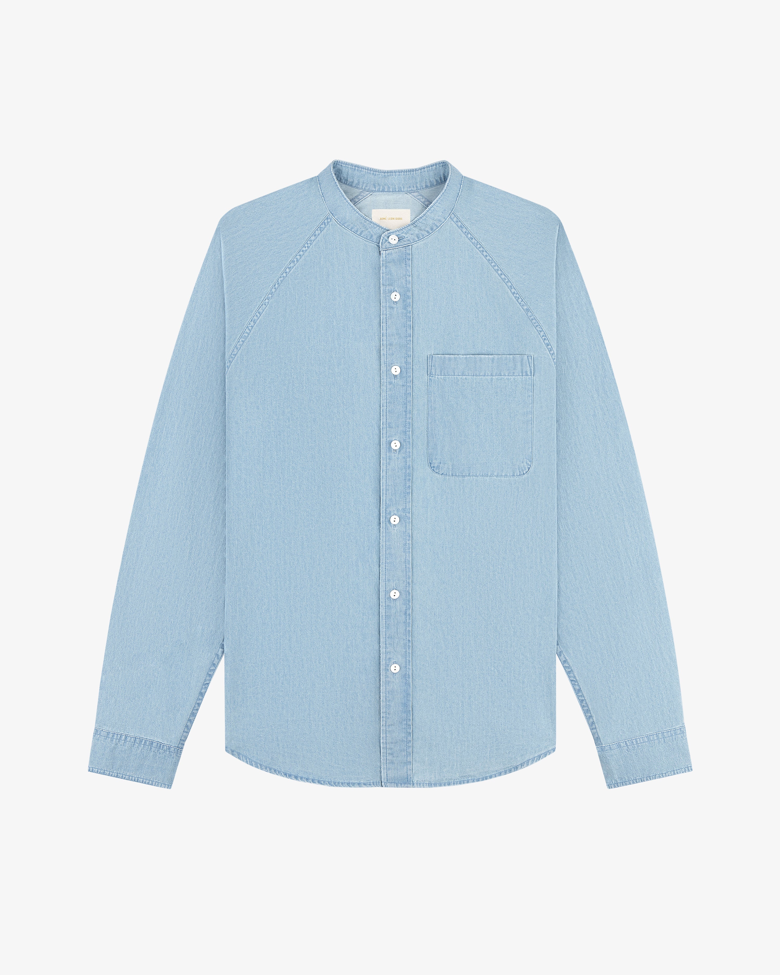 Denim Collarband Shirt, light blue, long sleeves, rounded collarband, chest pocket, flat on a white background.