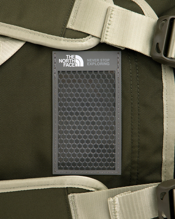 Close-up of ALD / The North Face Base Camp Duffel in green with beige straps and signature patch attached.