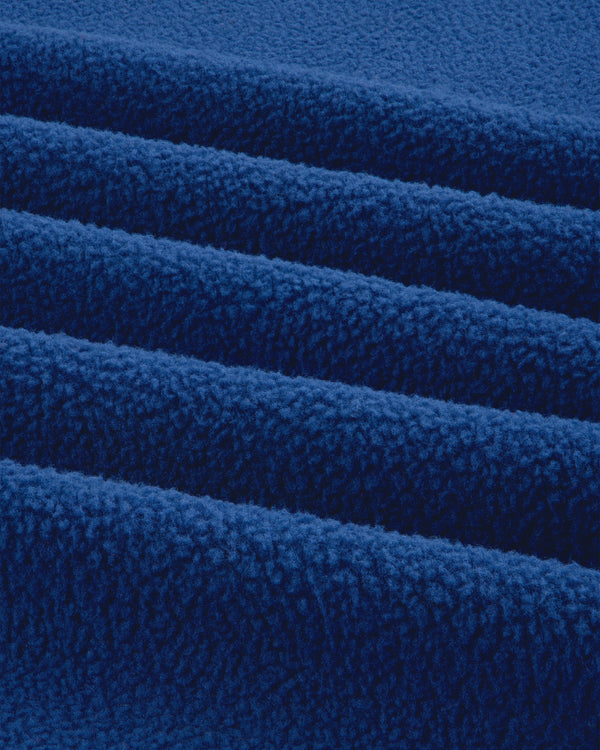 Close-up of the ALD / The North Face Packable Fleece Blanket, showing its soft, bright blue textured layers.