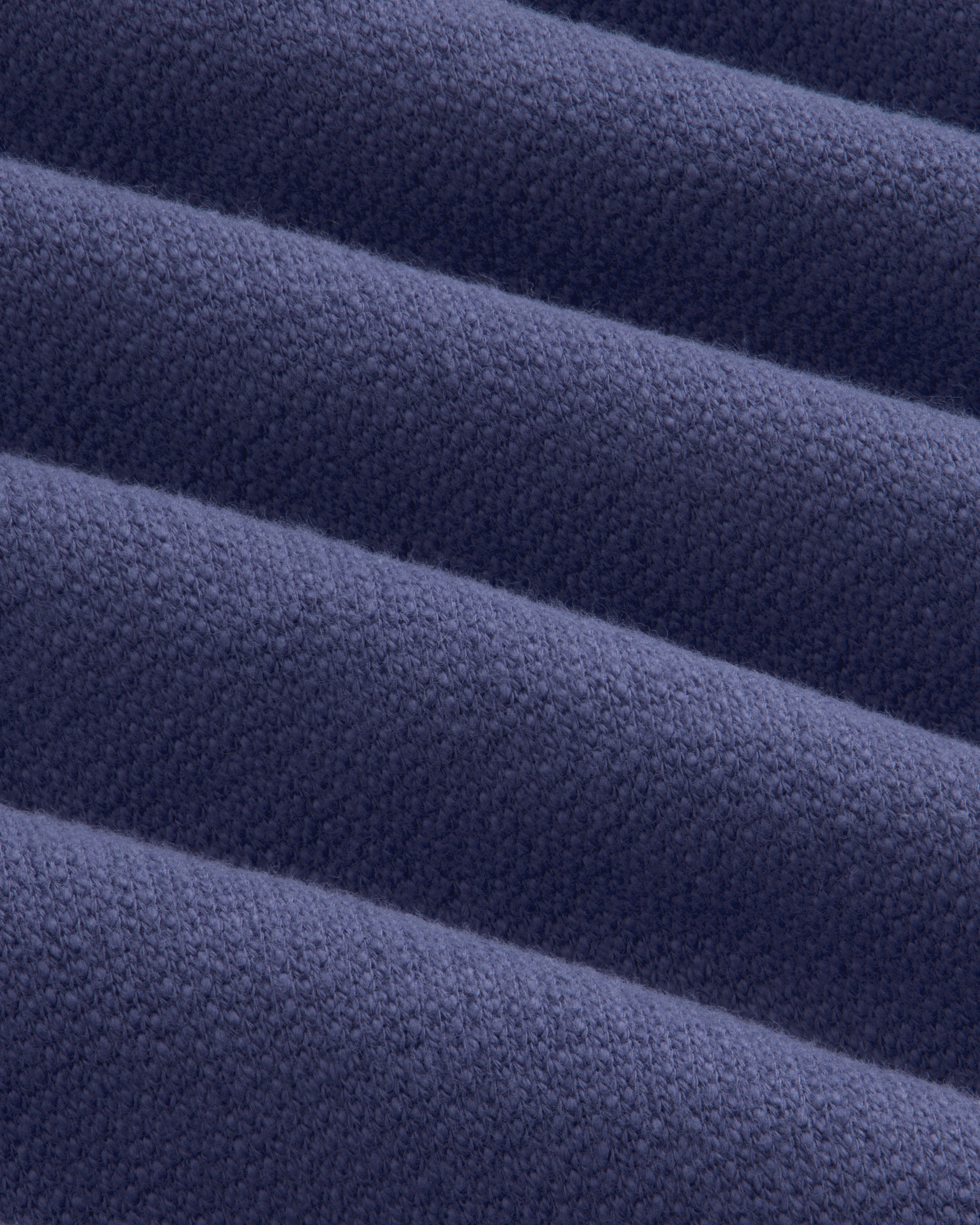 Close-up of soft, navy Stone Washed Marina Hoodie fabric with textured ridges and subtle woven detail.