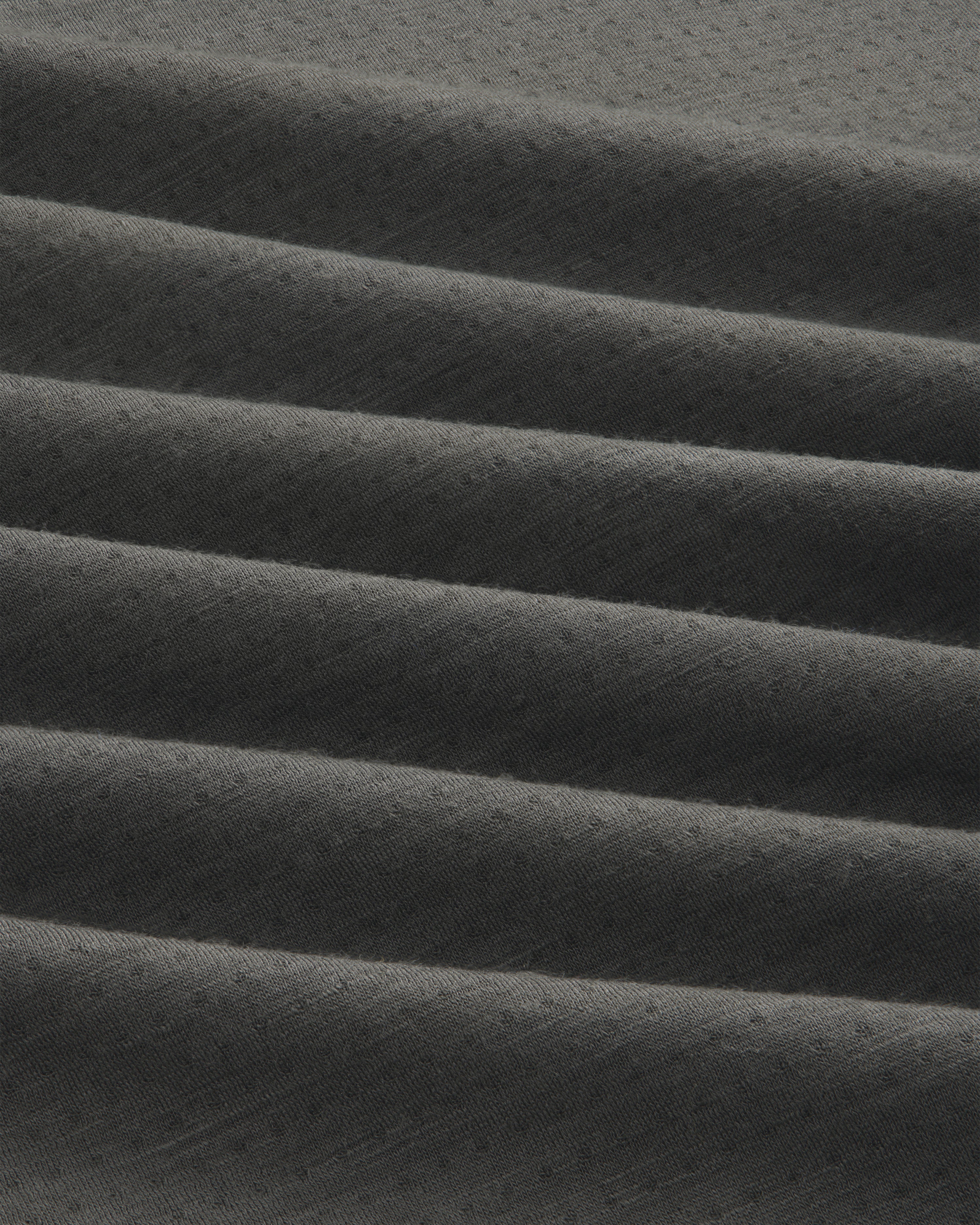 Dark gray ALD/The North Face DOTKNIT™ Wool Quarter Zip with subtle textured fabric in horizontal pleats.