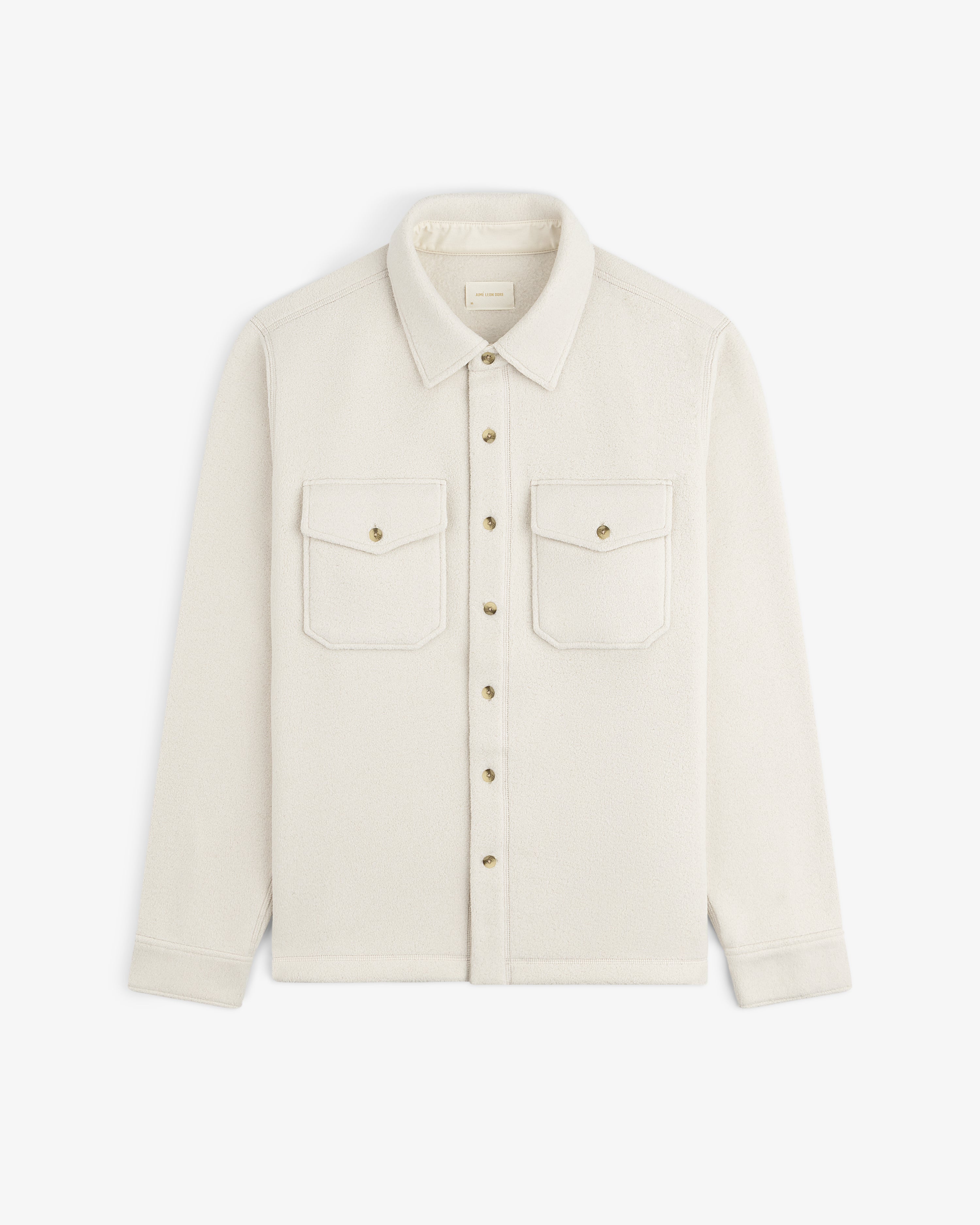 Melange Fleece Shirt—cream, long-sleeve, button-up with two chest pockets and collar, laid flat on white.