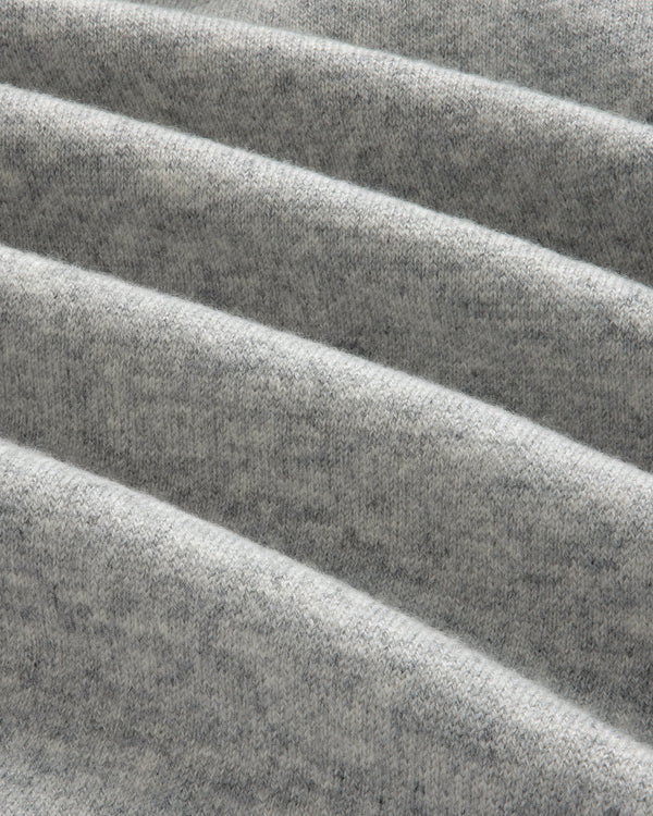 Close-up of folded, soft Pavilion Cashmere Hoodie in heather gray, showing texture and diagonal, parallel folds.