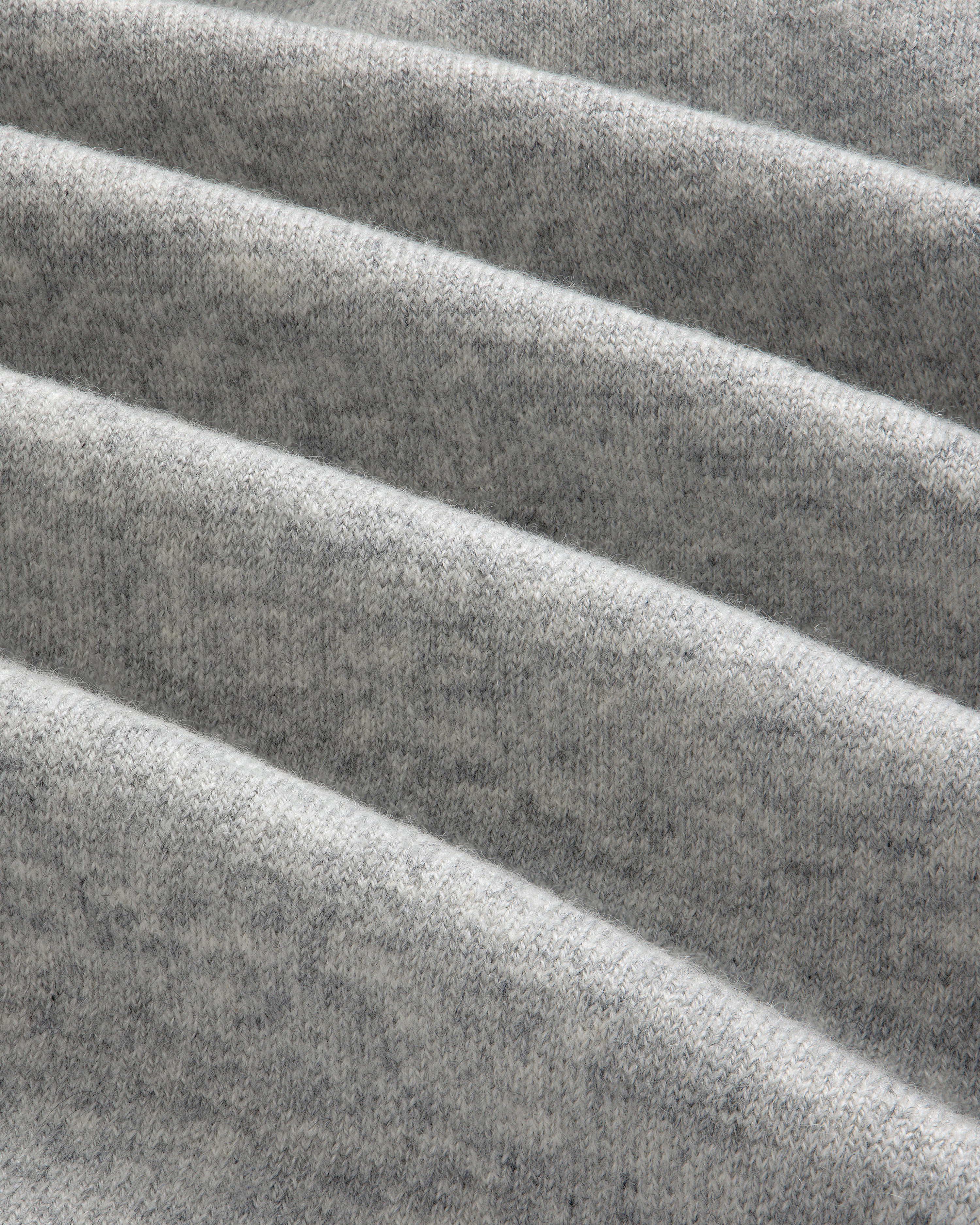 Close-up of folded Pavilion Cashmere Sweatpant in light gray, showing its soft, textured surface with horizontal ridges.
