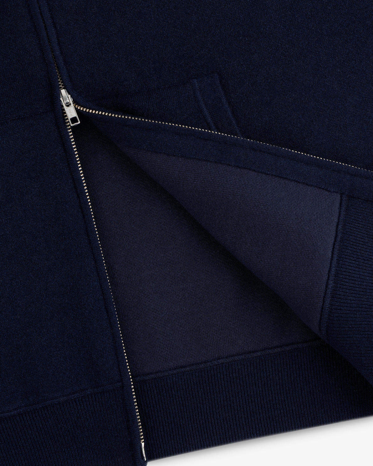 Close-up of the Full-Zip Pavilion Cashmere Hoodie in navy, partially unzipped to reveal inner fabric and stitching.