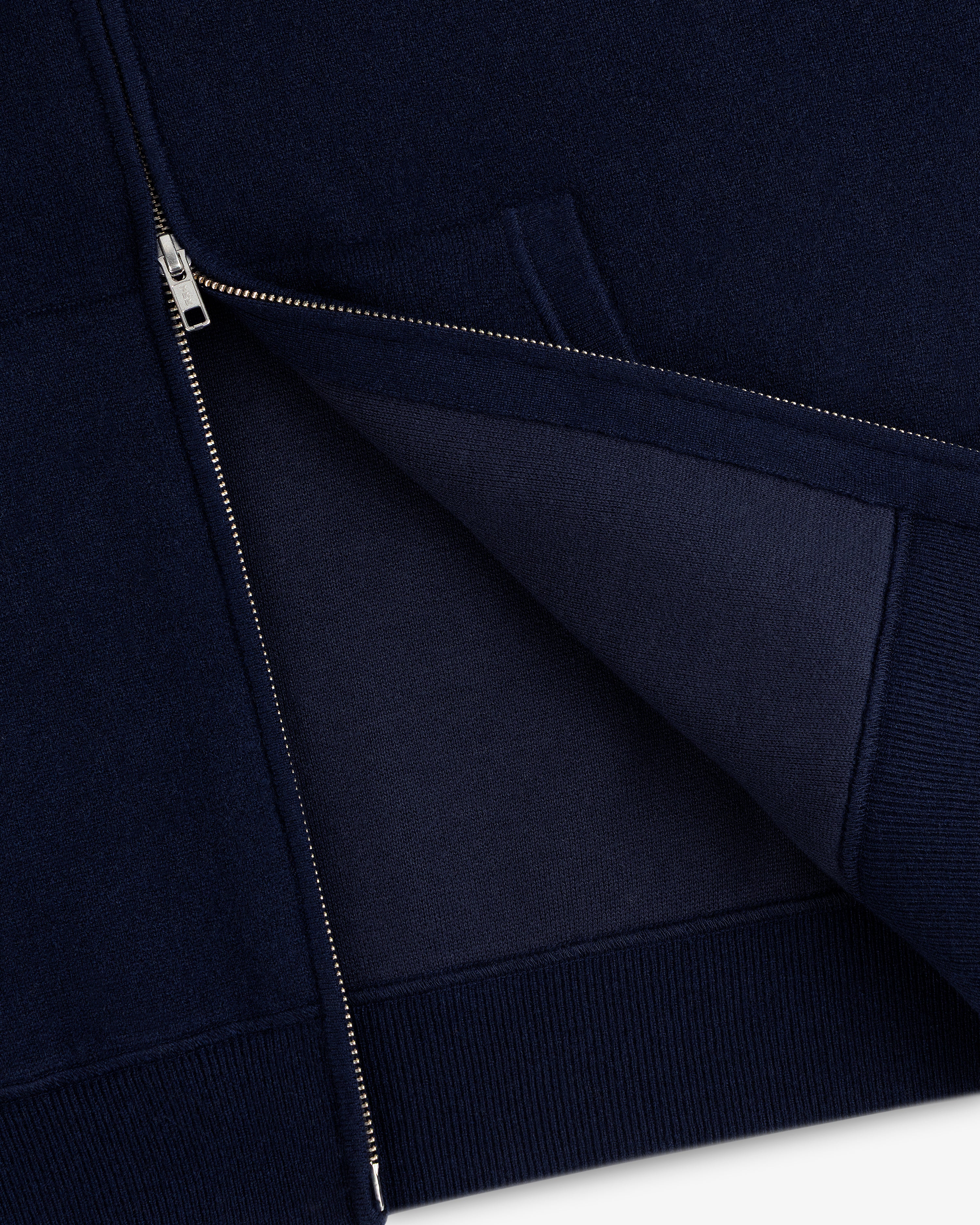 Close-up of the Full-Zip Pavilion Cashmere Hoodie in navy, partially unzipped to reveal inner fabric and stitching.