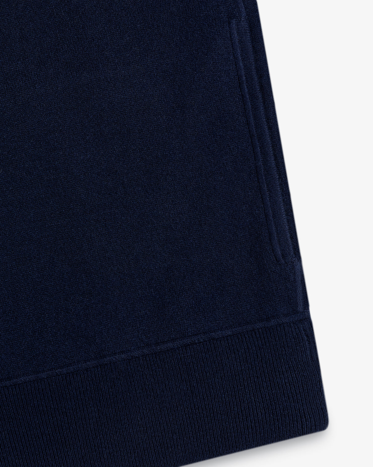 Close-up of a Quarter Zip Pavilion Cashmere Pullover in navy blue with pocket and ribbed hem on white background.