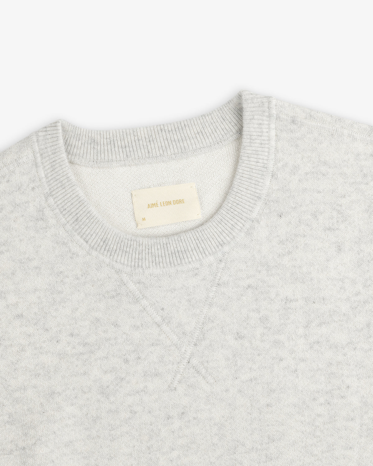 Light gray Pavilion Cashmere Crewneck Sweatshirt with ribbed collar and AIME LEON DORE tag inside.
