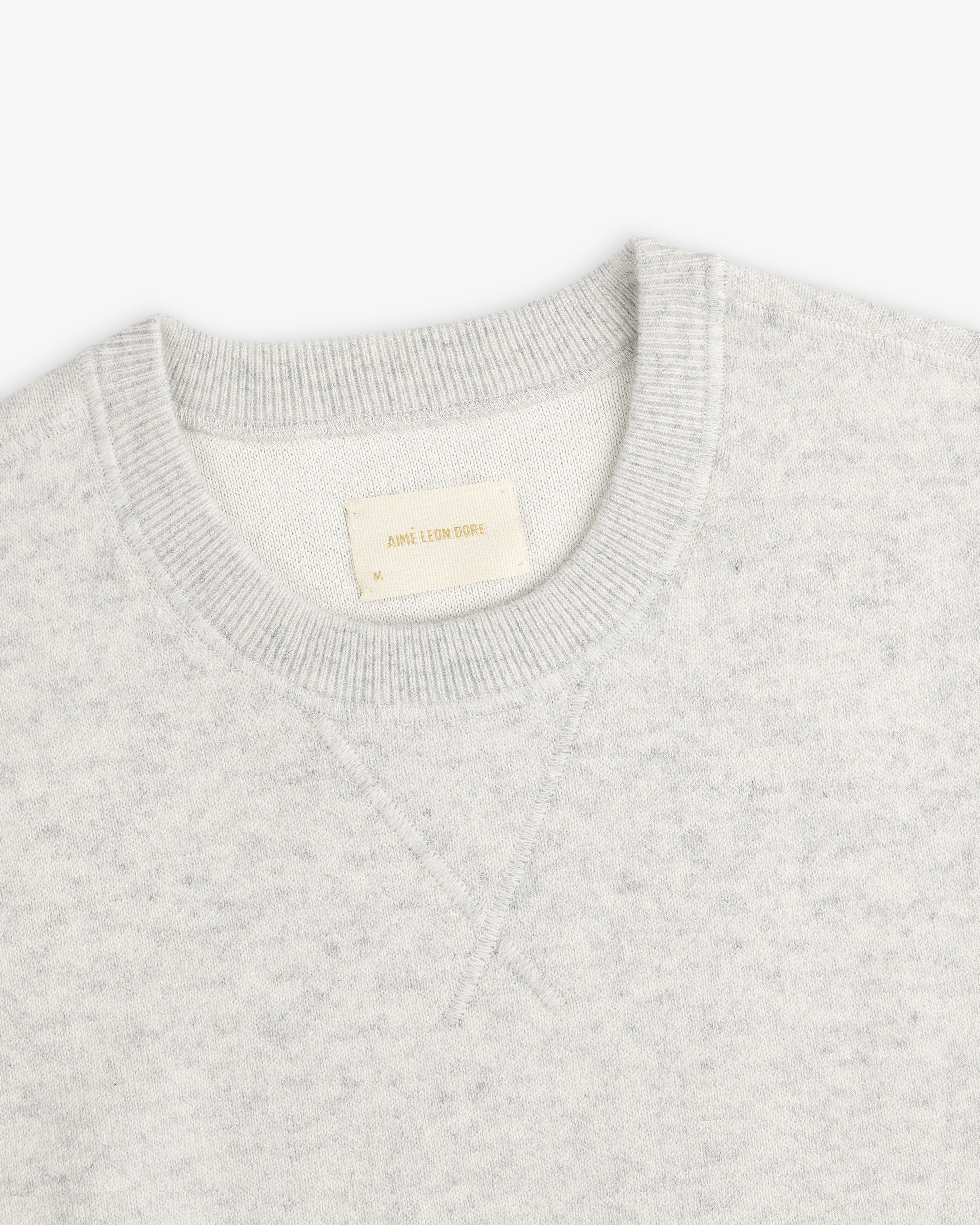 Light gray Pavilion Cashmere Crewneck Sweatshirt with ribbed collar and AIME LEON DORE tag inside.