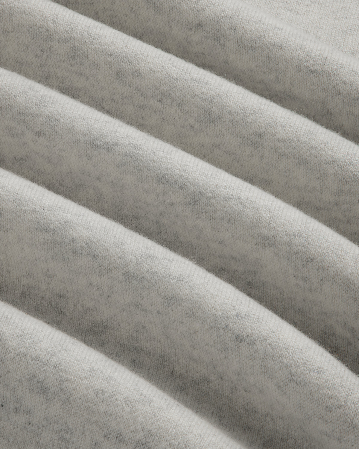 Close-up of Pavilion Cashmere Crewneck Sweatshirt in light gray, showing soft ribbed fabric and horizontal ridges.