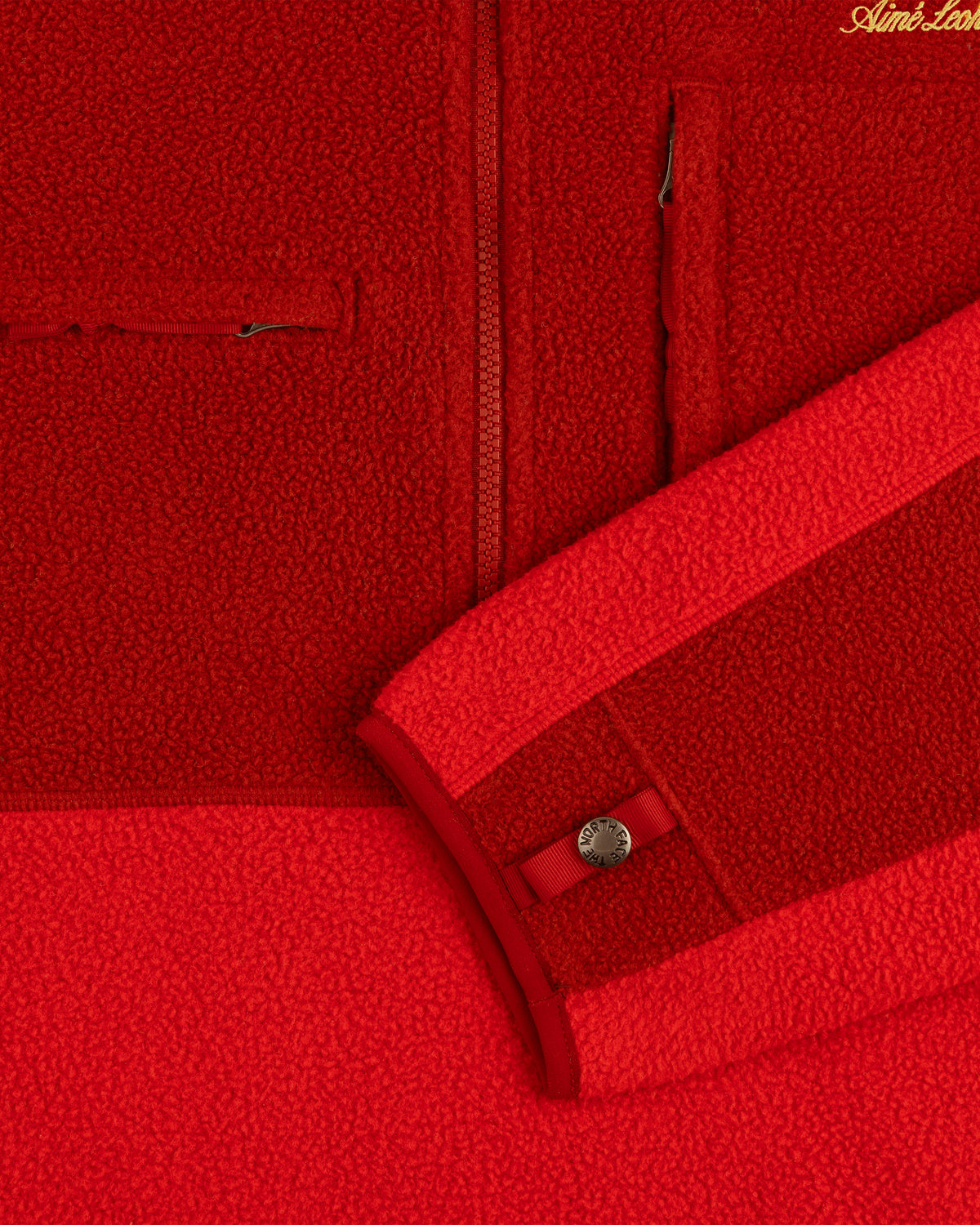 ALD/The North Face ’95 Denali Half-Zip Fleece Pullover in red, with pocket, zipper, and snap button sleeve cuff.