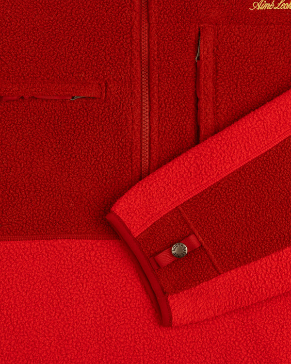 ALD/The North Face ’95 Denali Half-Zip Fleece Pullover in red, with pocket, zipper, and snap button sleeve cuff.