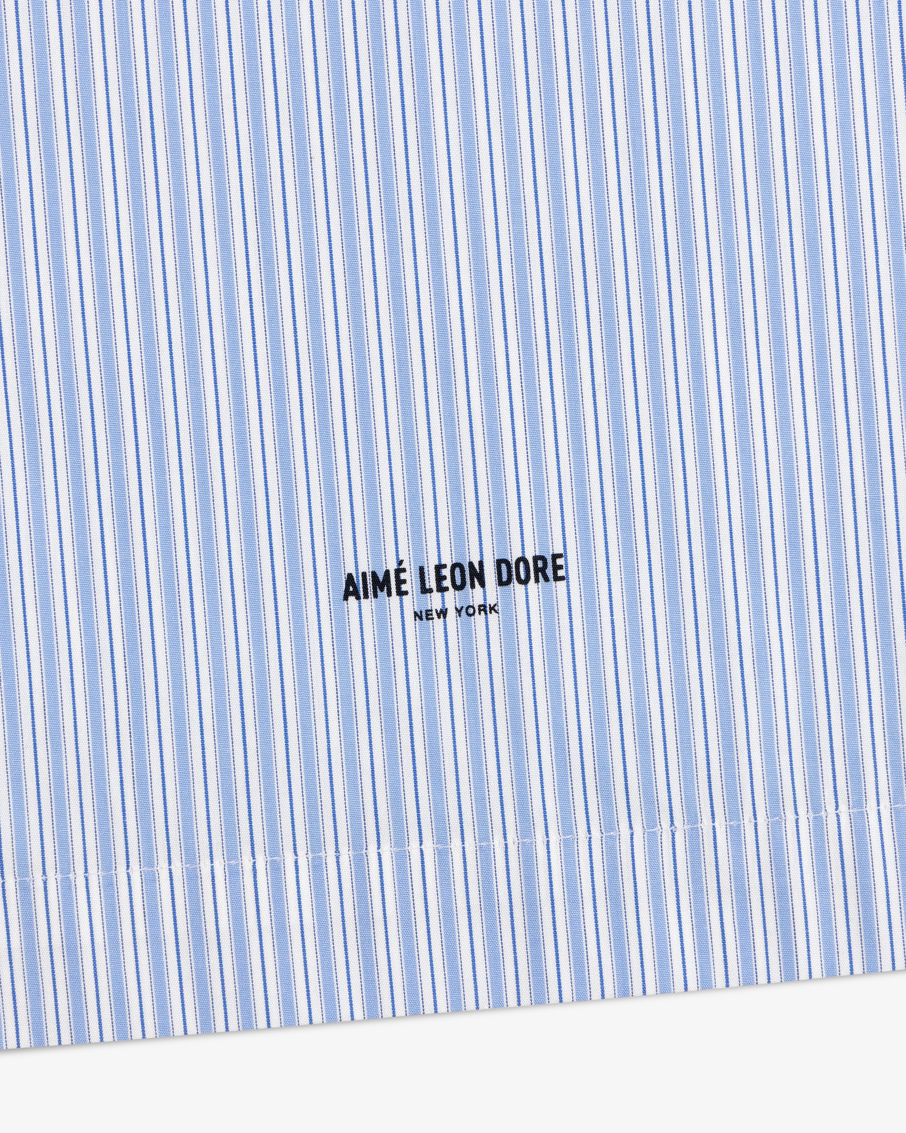 Poplin Casual Shirt in light blue and white stripes with AIMÉ LEON DORE NEW YORK logo printed in black.