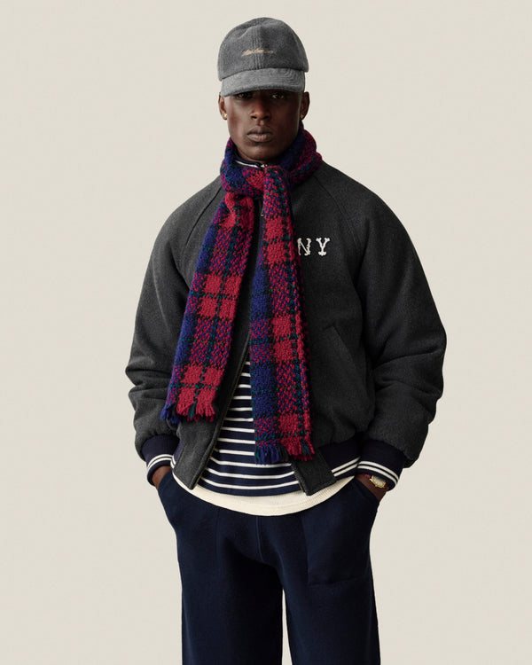 Man in Striped Crest Quarter Zip stands with hands in pockets against a plain background.