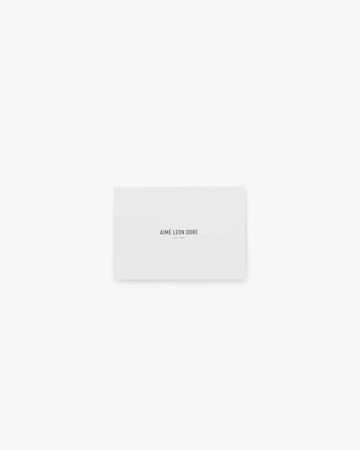 A white rectangular Aimé Leon Dore Gift Card with the brand name printed in black at the center.