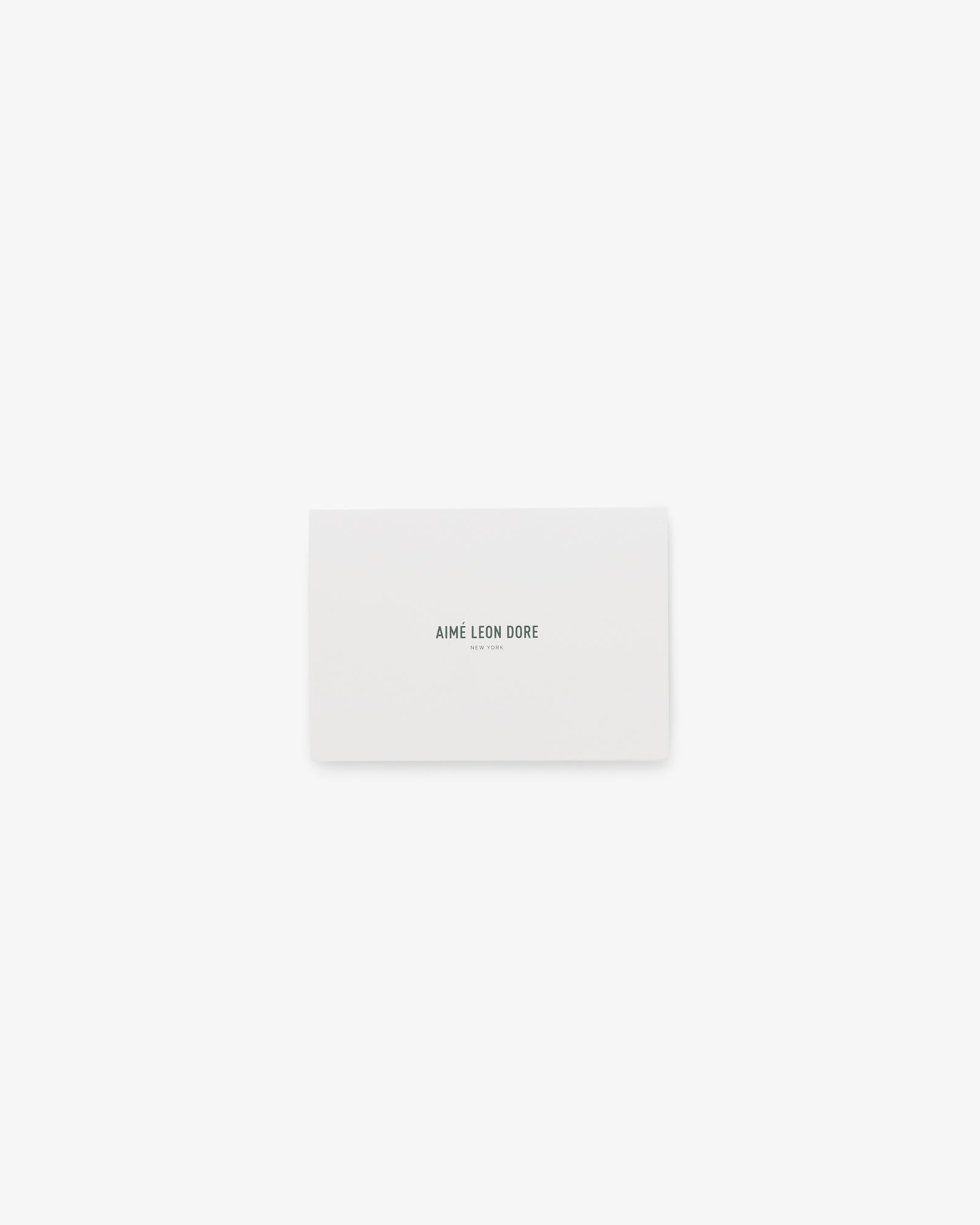 A white rectangular Aimé Leon Dore Gift Card with the brand name printed in black at the center.