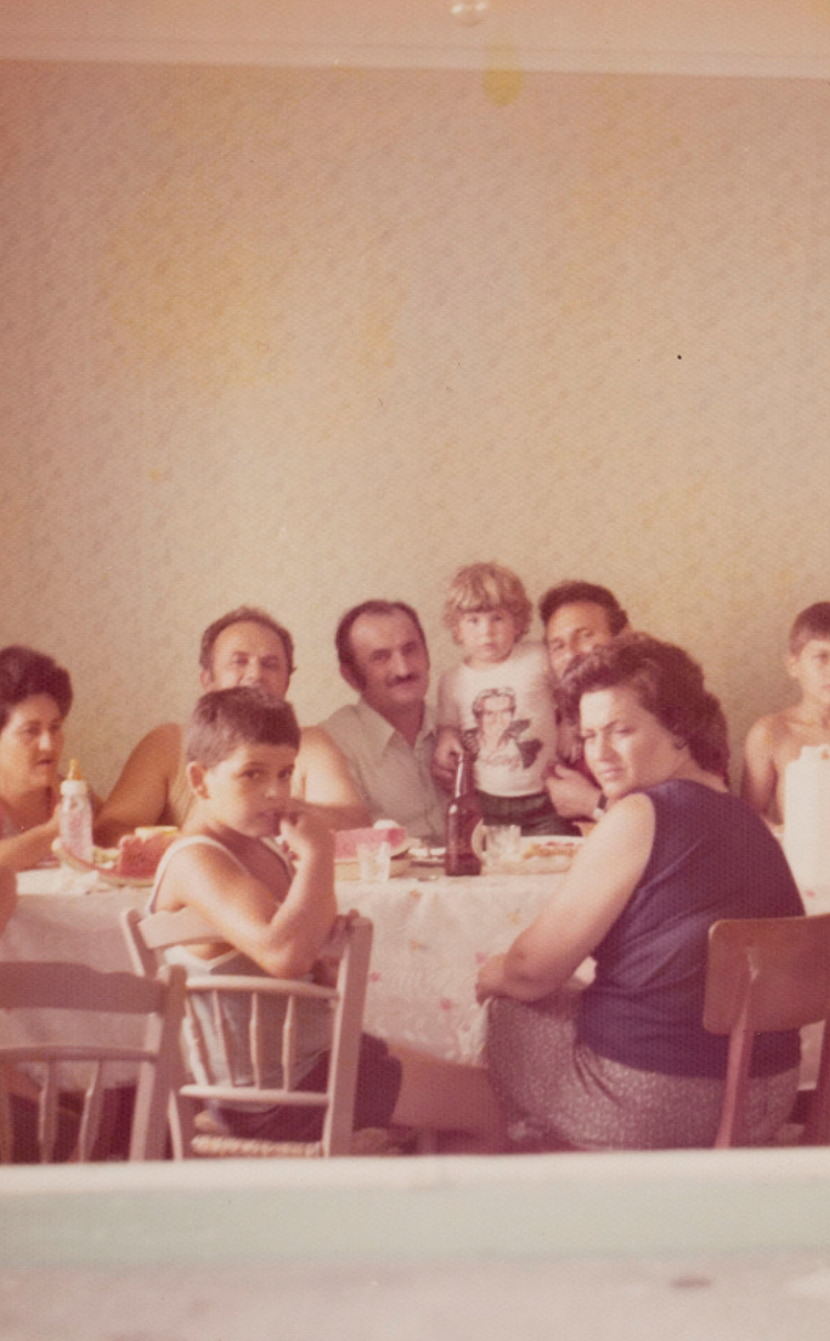 Large family posing for photo at kitchen table