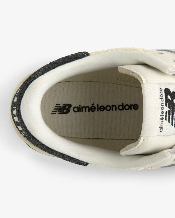 Top view of ALD / New Balance 475 white sneaker with logos on the insole and tongue.