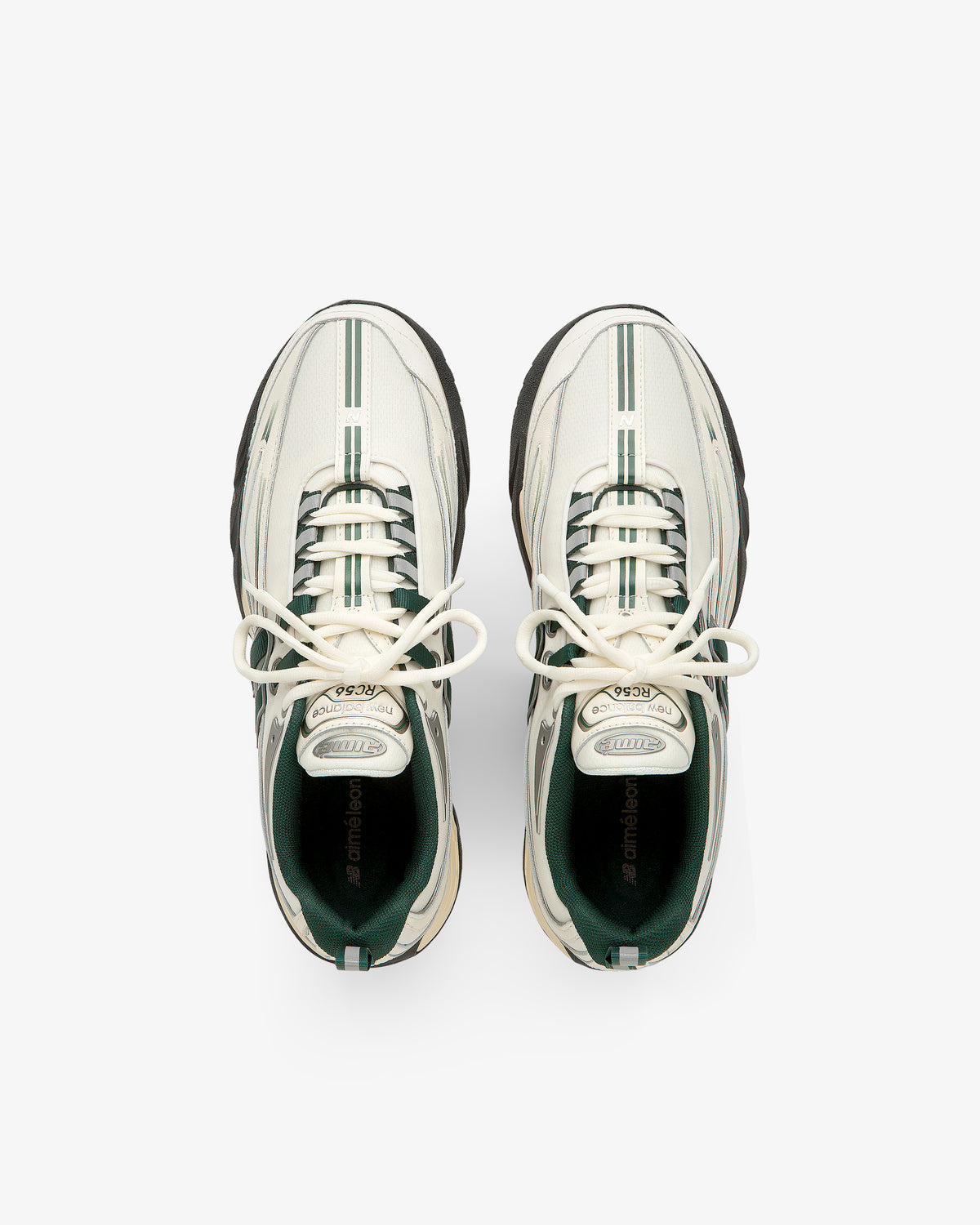 ALD / New Balance RC56 white sneakers with green stripes and black soles, viewed from above on a white background.