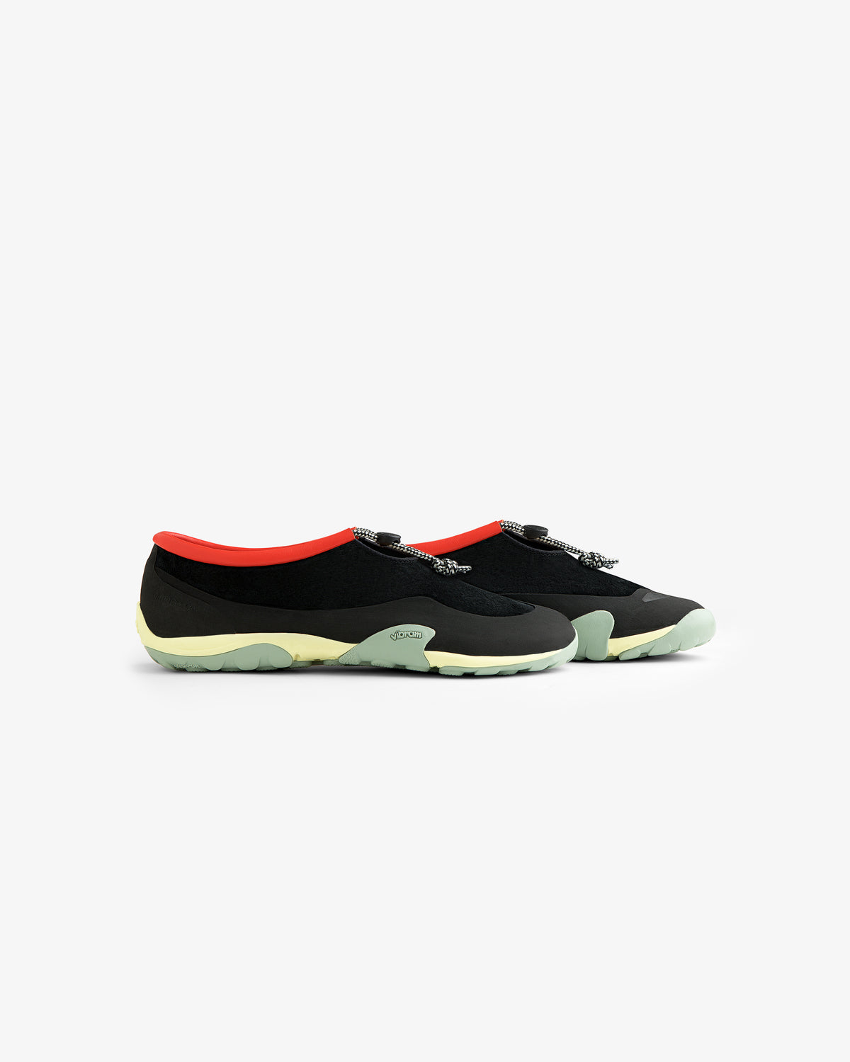 ALD / New Balance MT10T Sport Shoe: black slip-ons with red trim, patterned laces, and light green soles.
