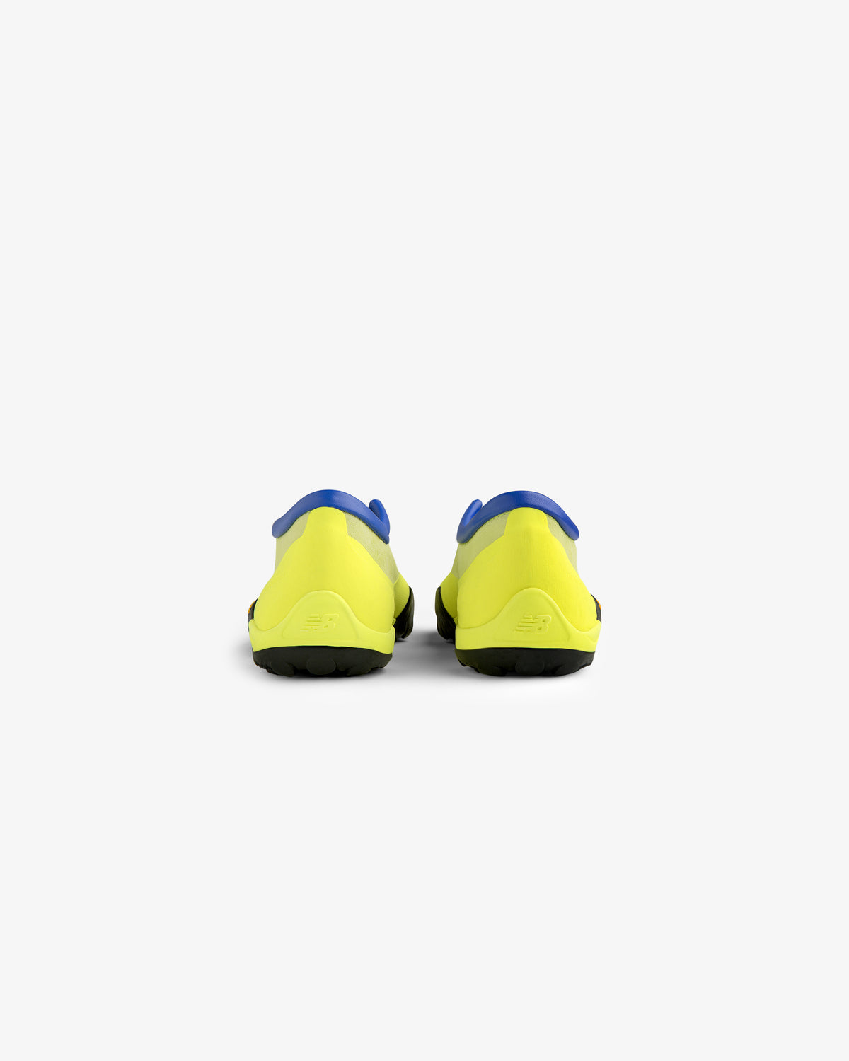Rear view of ALD / New Balance MT10T Sport Shoes—yellow with blue accents and black soles on white background.
