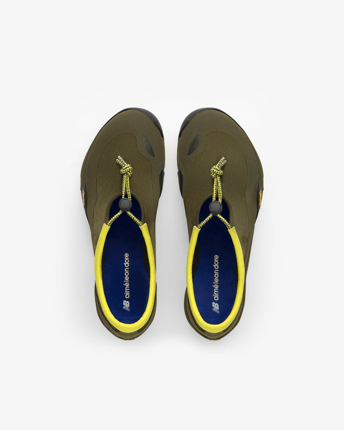 Top view of ALD / New Balance MT10T Sport Shoe in olive green with yellow lining and elastic lace closure.