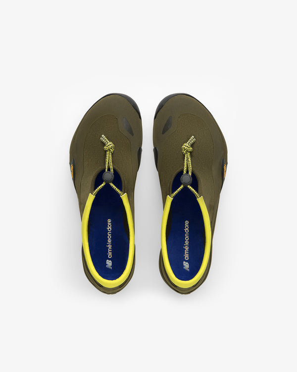 Top view of ALD / New Balance MT10T Sport Shoe in olive green with yellow lining and elastic lace closure.