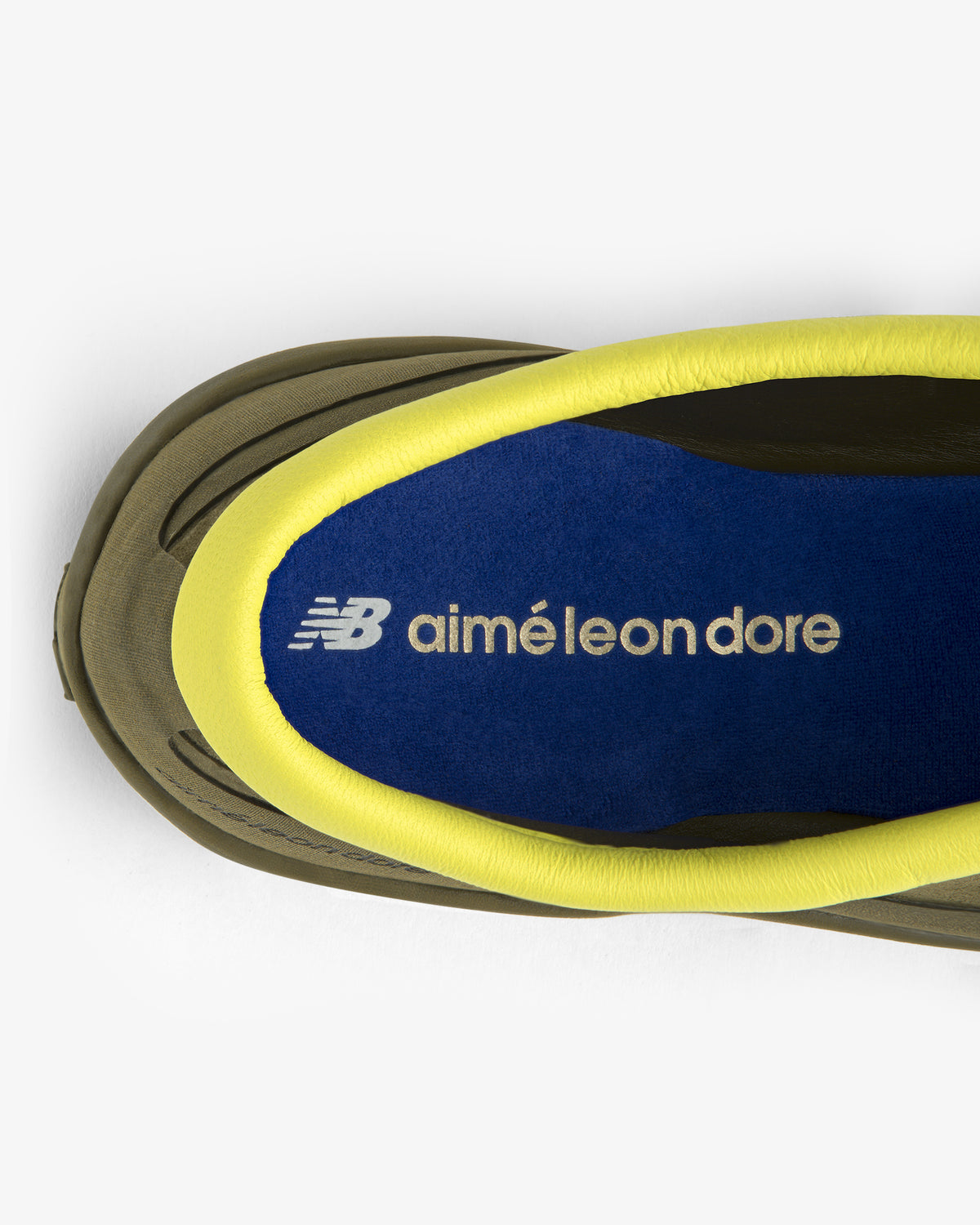 Top view of ALD / New Balance MT10T Sport Shoe with blue insole, white logo text, and yellow lining.