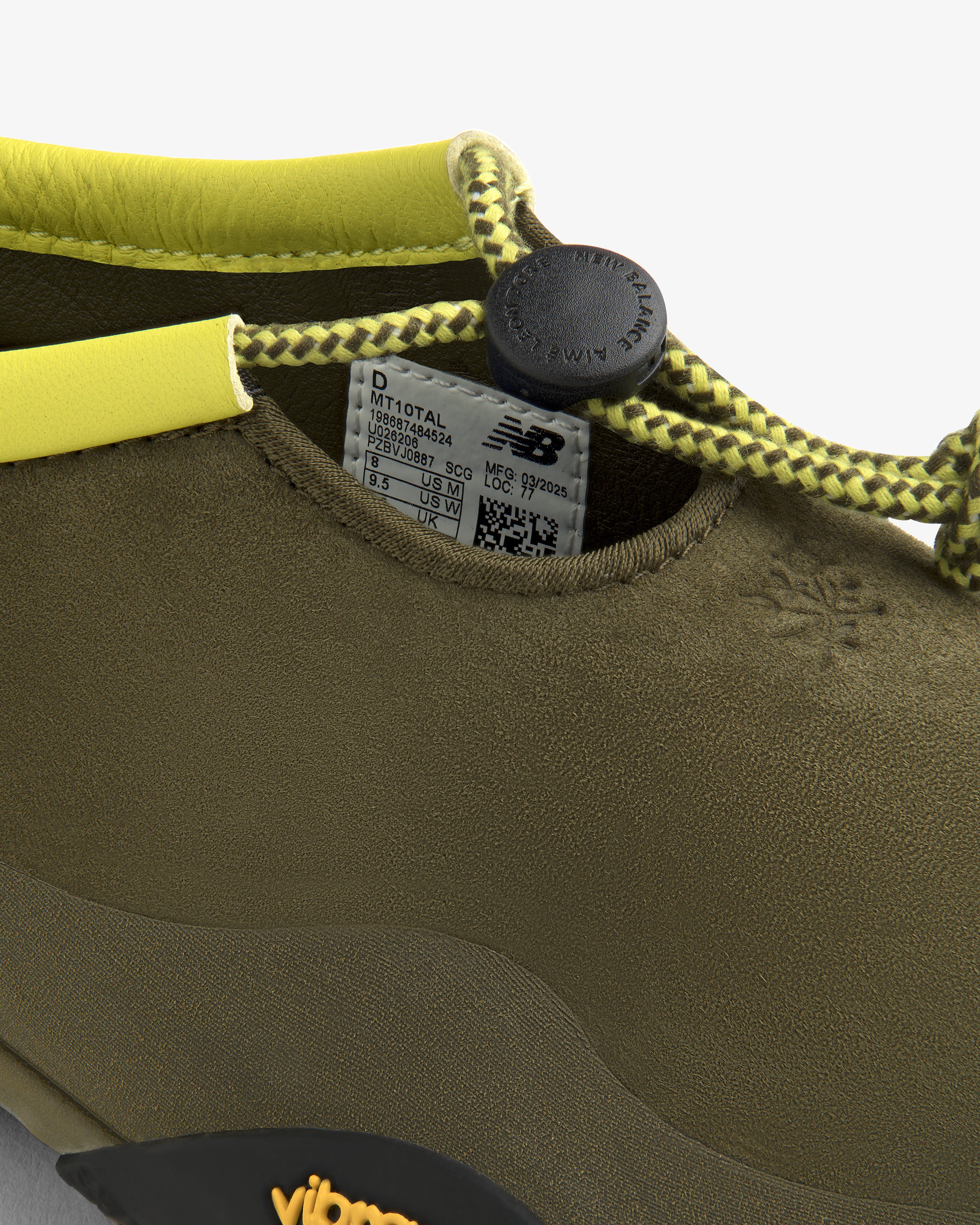Close-up of the ALD / New Balance MT10T Sport Shoe in olive green with yellow lace, black toggle, and NB label inside.