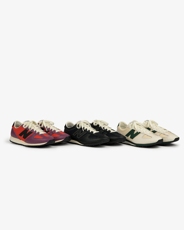 Three ALD / New Balance 471 sneakers in red, black, and beige with unique N logos, lined up on a white background.