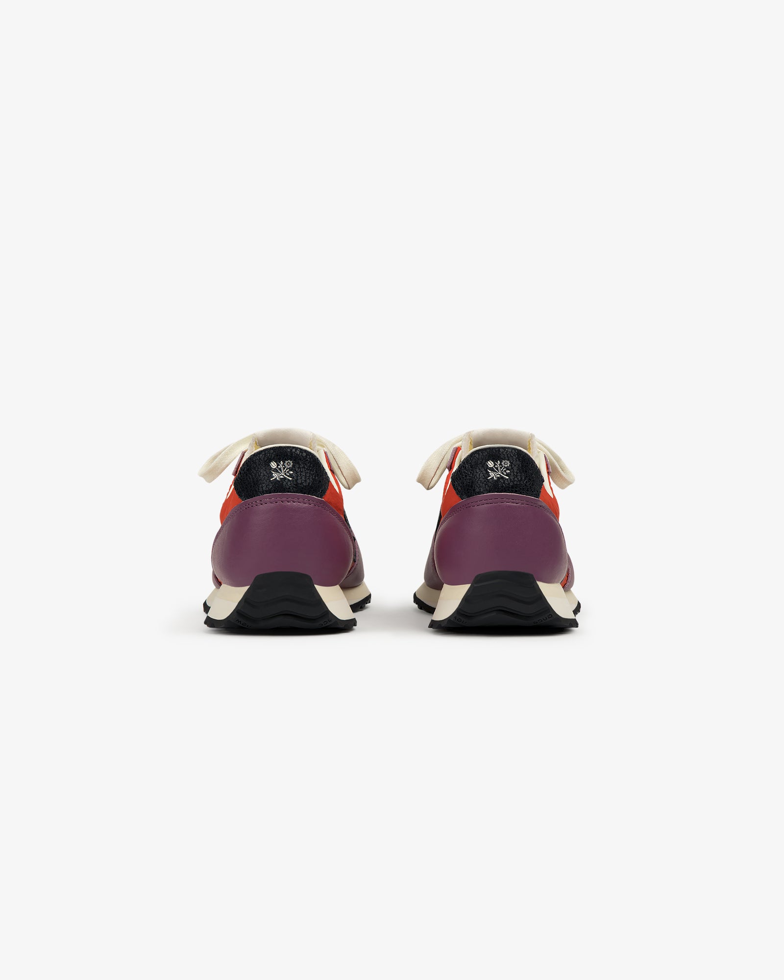 The ALD / New Balance 471 sneakers in purple and red, with white laces and black soles, shown from the back.