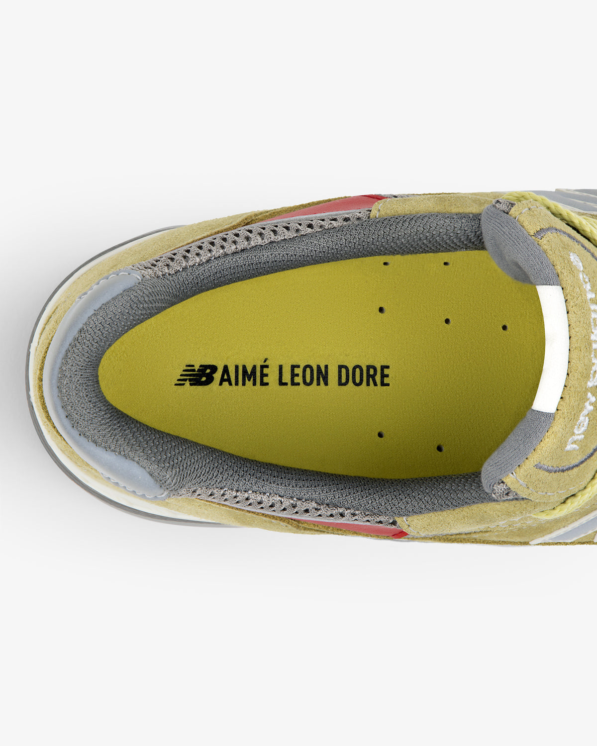 Top view of ALD / New Balance Made in UK 991 insole with NB AIMÉ LEON DORE printed in black on yellow.