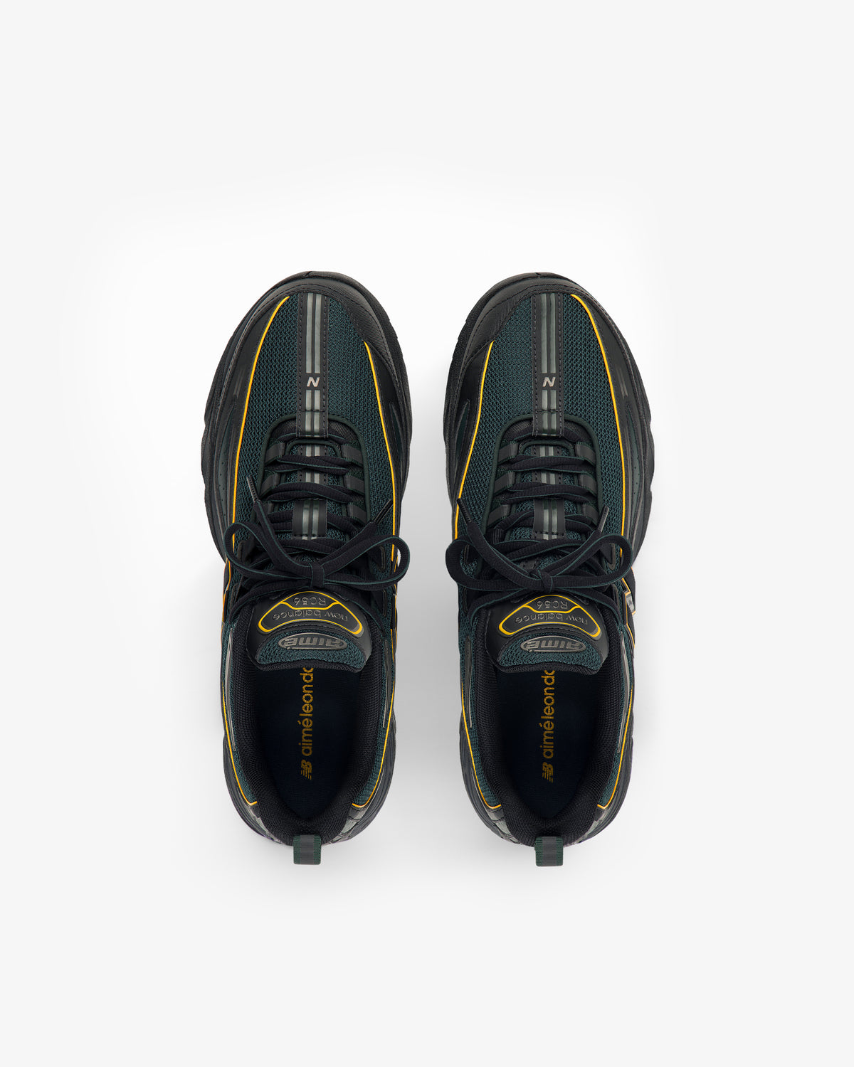 A pair of ALD / New Balance RC56 black sneakers with yellow accents, shown from above on a white background.