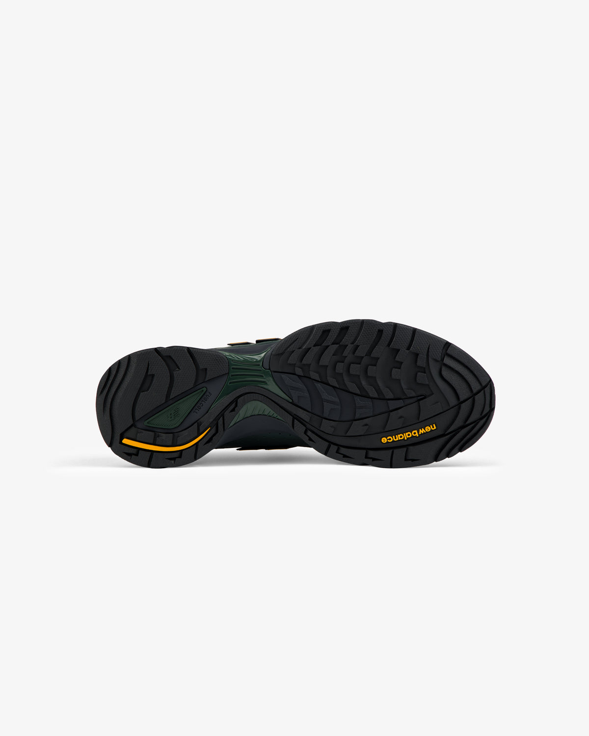 The black rubber sole of the ALD / New Balance RC56 with yellow accents, seen from below on a white background.