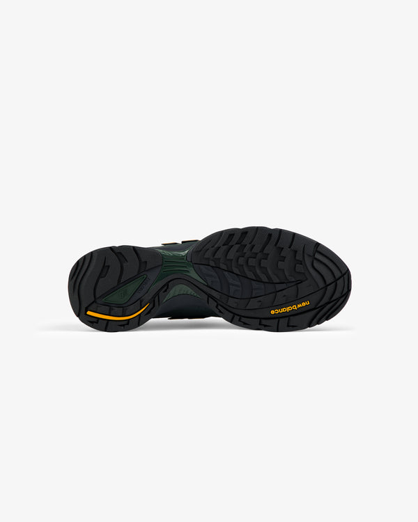 The black rubber sole of the ALD / New Balance RC56 with yellow accents, seen from below on a white background.