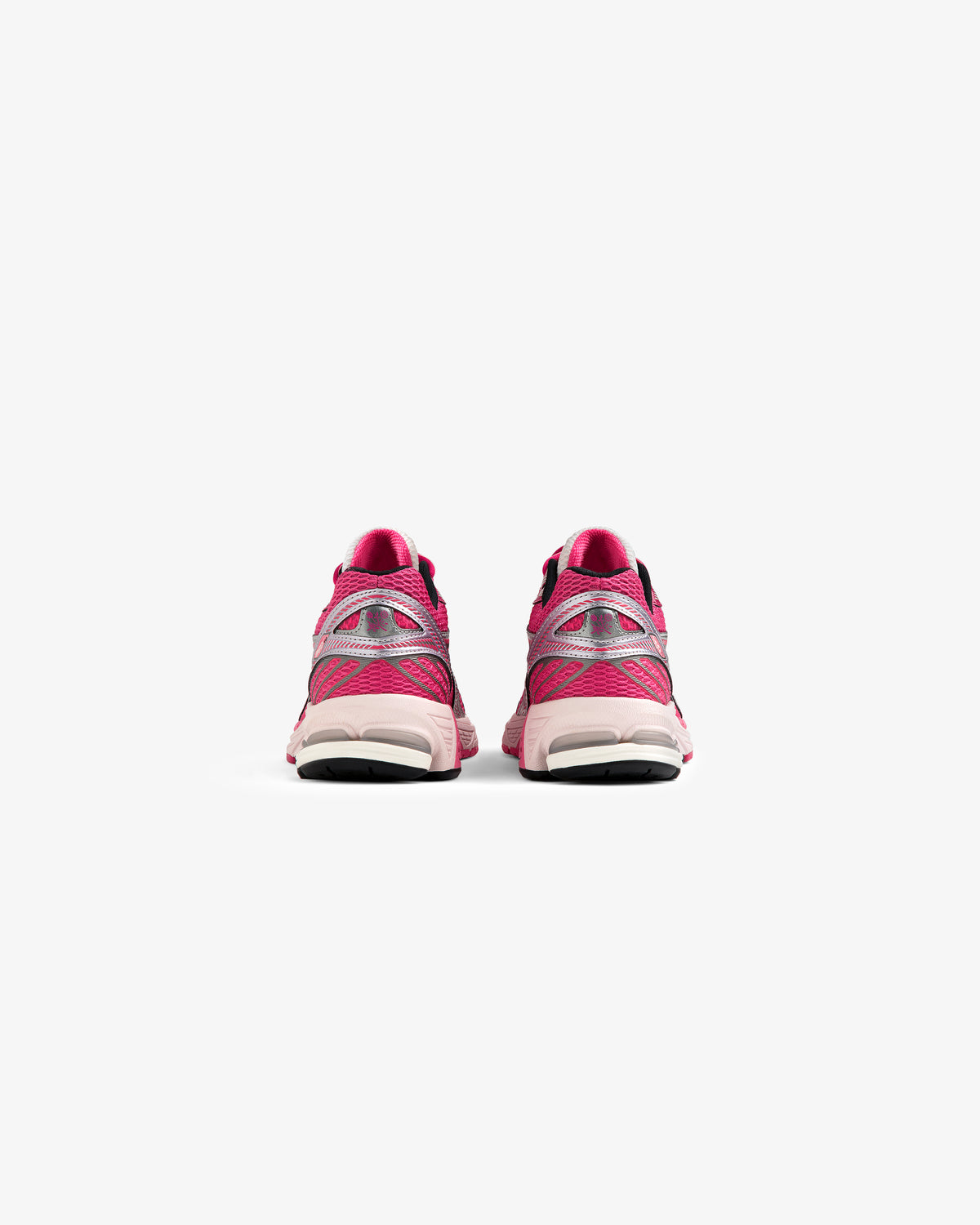 A pair of ALD / New Balance 860v2 pink sneakers seen from the back on a white background.