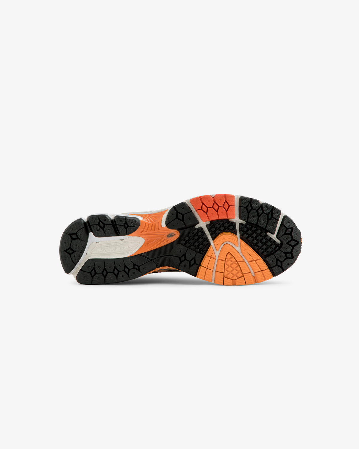 The ALD / New Balance 860v2 sneaker’s orange, black, and beige rubber outsole viewed from below on a white background.