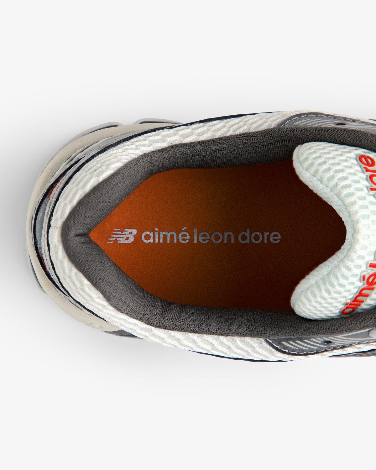 Top view of the ALD / New Balance 860v2 sneaker with orange insole featuring aimé leon dore branding.