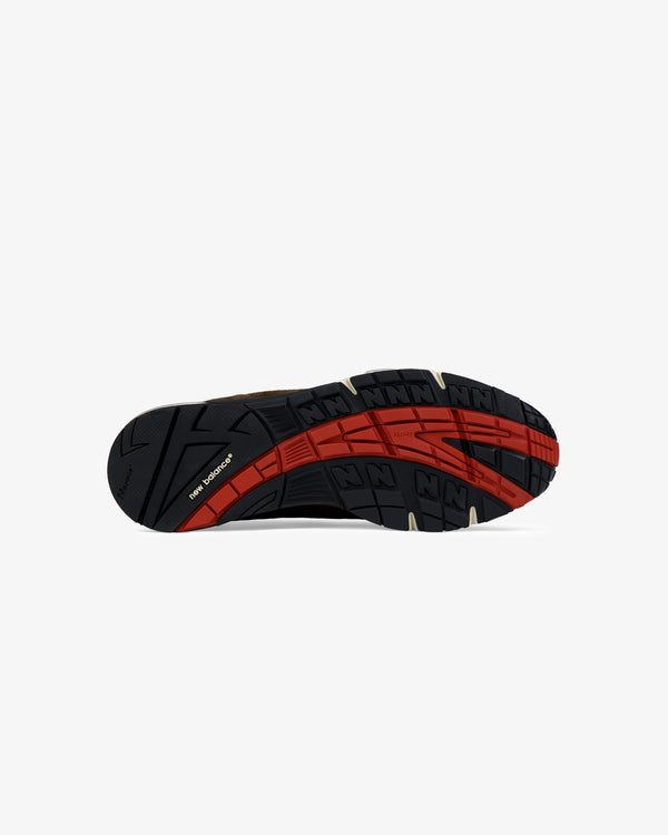 Black sole with red and tan accents, textured tread, and ALD / New Balance Made in UK 991 branding underneath.