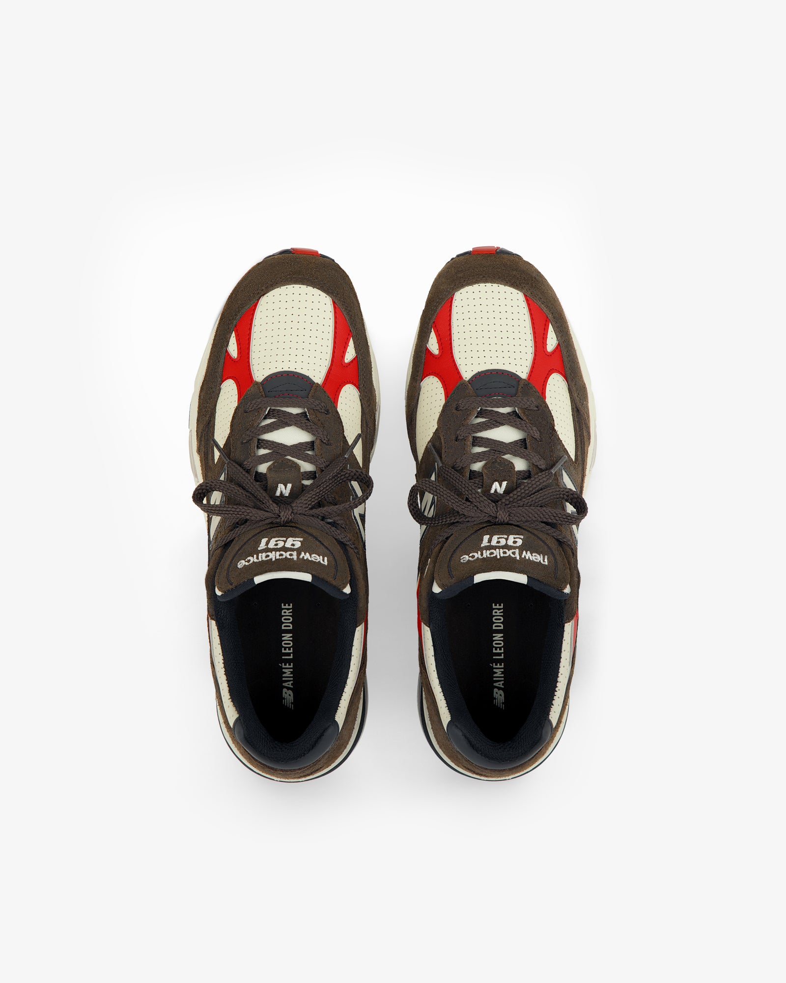 A pair of brown, cream, and red ALD / New Balance Made in UK 991 sneakers viewed from above on a white background.