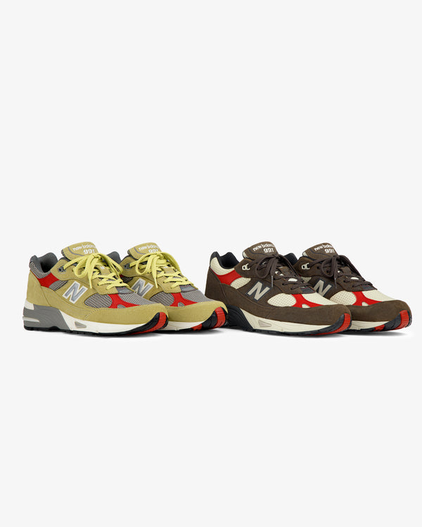 Two pairs of ALD / New Balance Made in UK 991 sneakers in yellow and brown, side by side on a white background.
