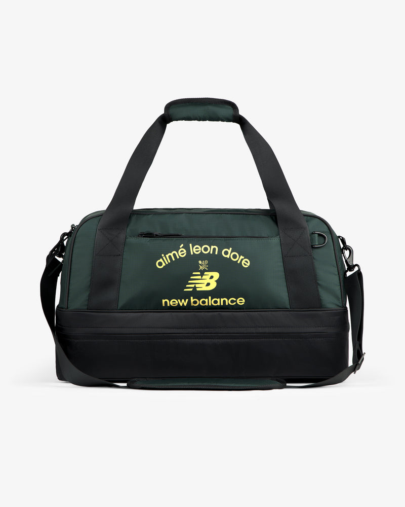 Dark green ALD / New Balance Travel Duffle Bag with black straps and yellow logos on the front.