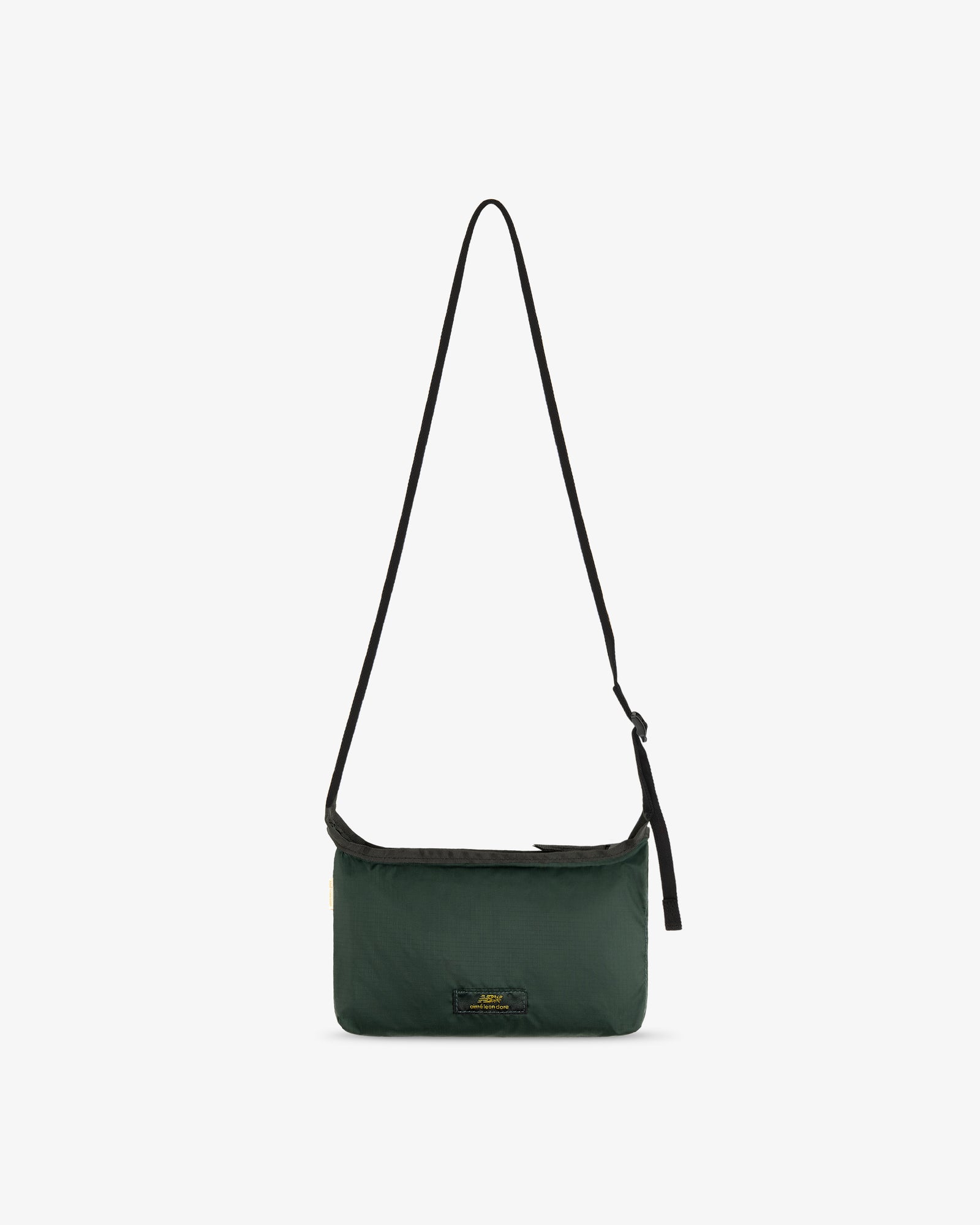 ALD / New Balance Nylon Sling Pouch, dark green with a long black strap and small front logo on white background.