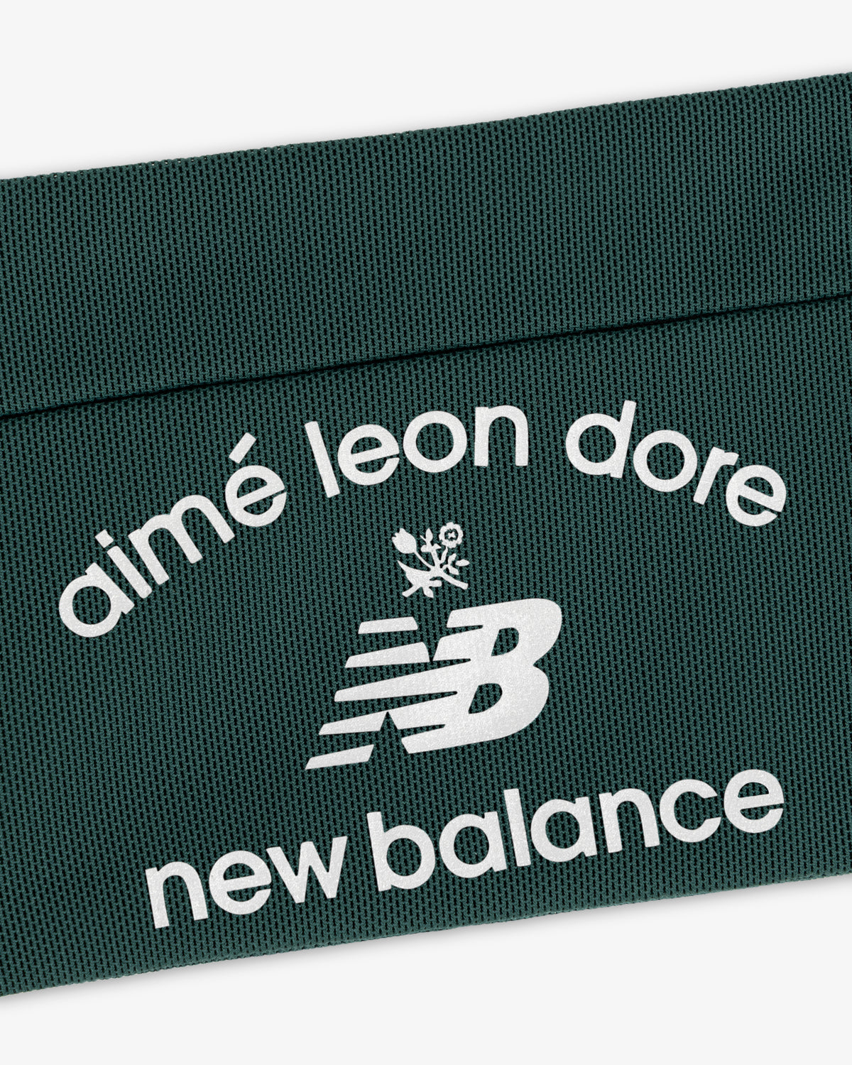 Dark green ALD / New Balance Performance Running Belt with white logo and text on textured surface.