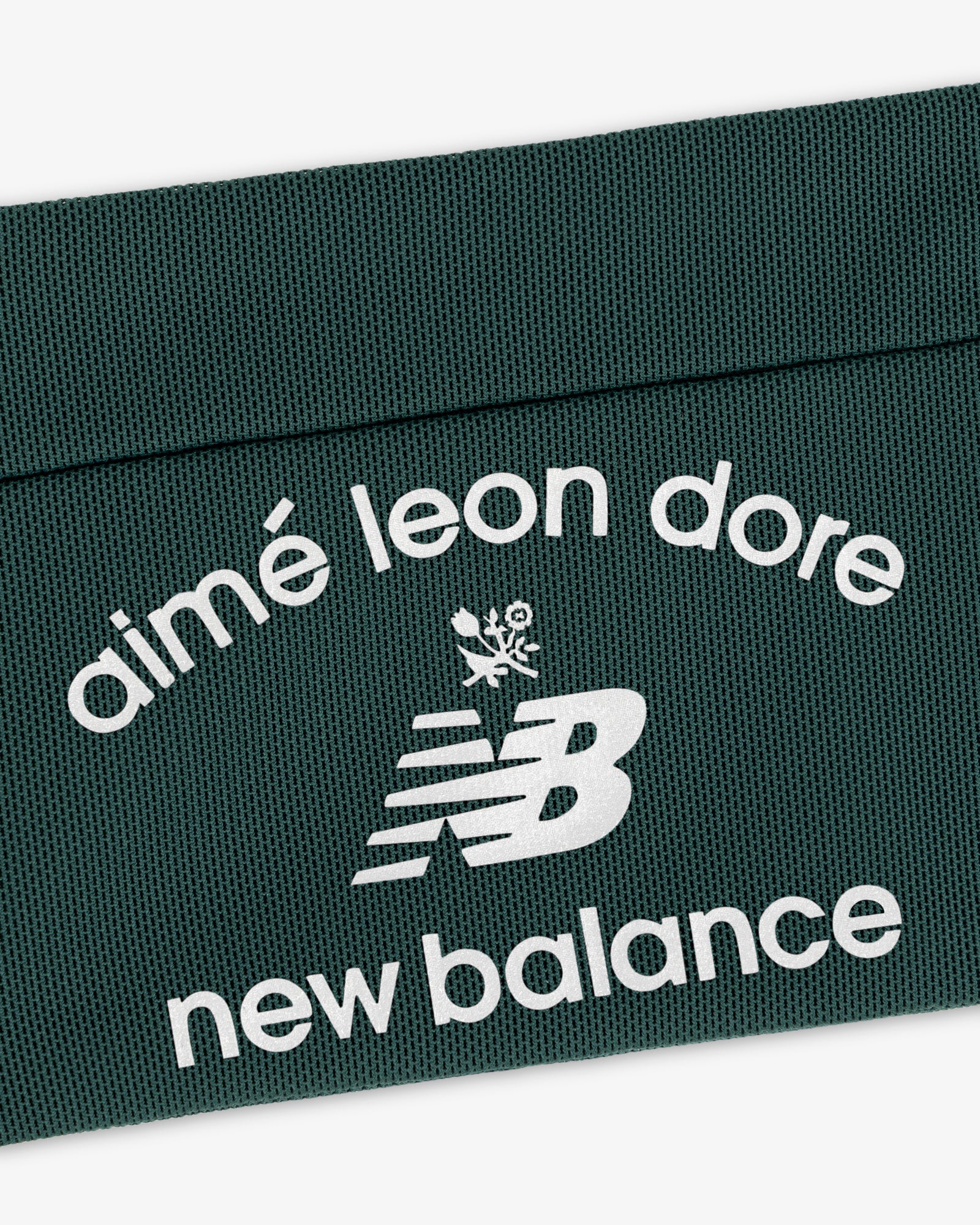 Dark green ALD / New Balance Performance Running Belt with white logo and text on textured surface.