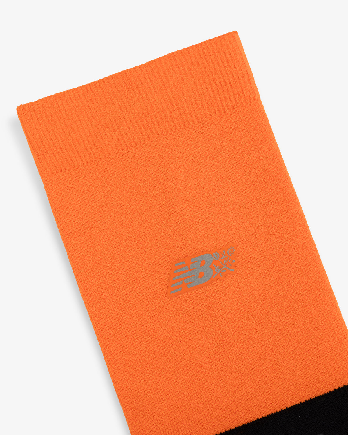 Bright orange ALD / New Balance Running Crew Sock with a silver logo near the top and a solid black section at the bottom.