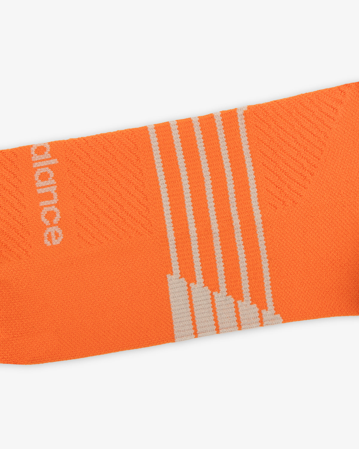 Close-up of ALD / New Balance Running Crew Sock—orange with white stripes and partial white text on the side.