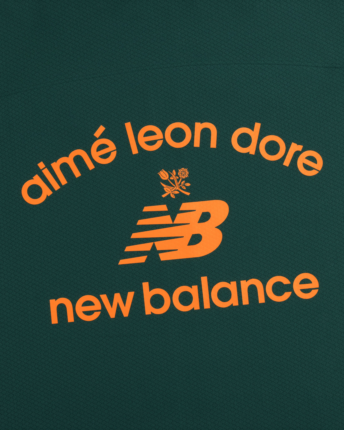 The ALD / New Balance Full-Zip Warmup Hoodie features orange logos on a dark green textured background.